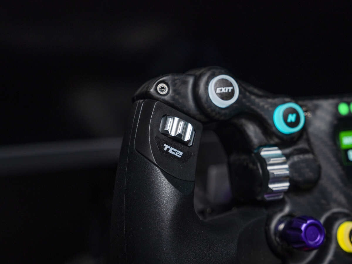 Close-up of the CONSPIT 300GT sim racing wheel featuring detailed controls and a carbon fiber design