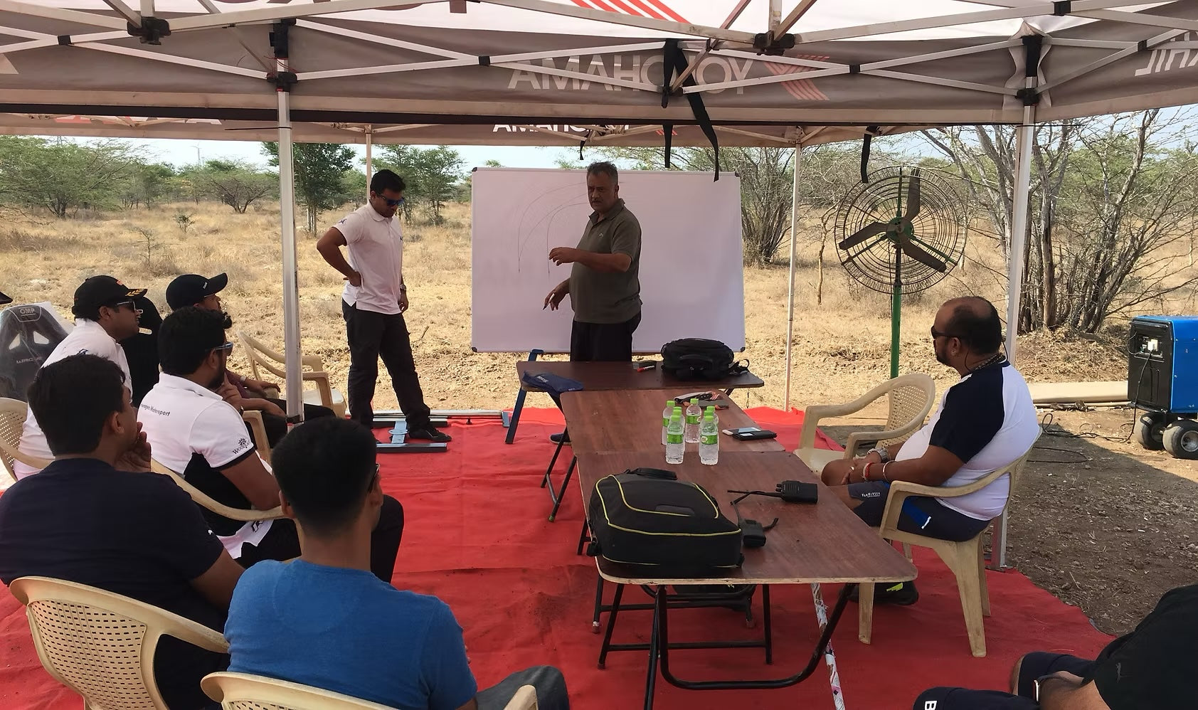 RaceSims Academy driver briefing with racing-line whiteboard